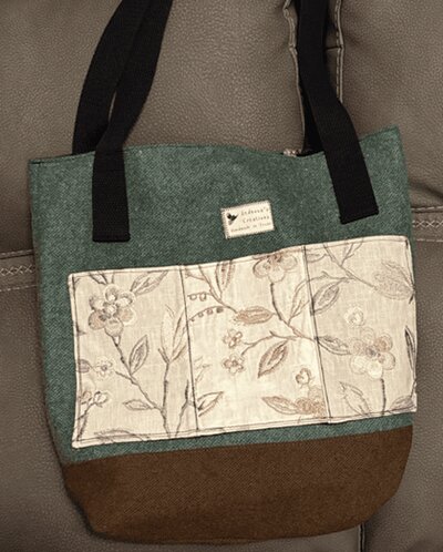 Tote bag with triptych-style floral panel making three individual pockets